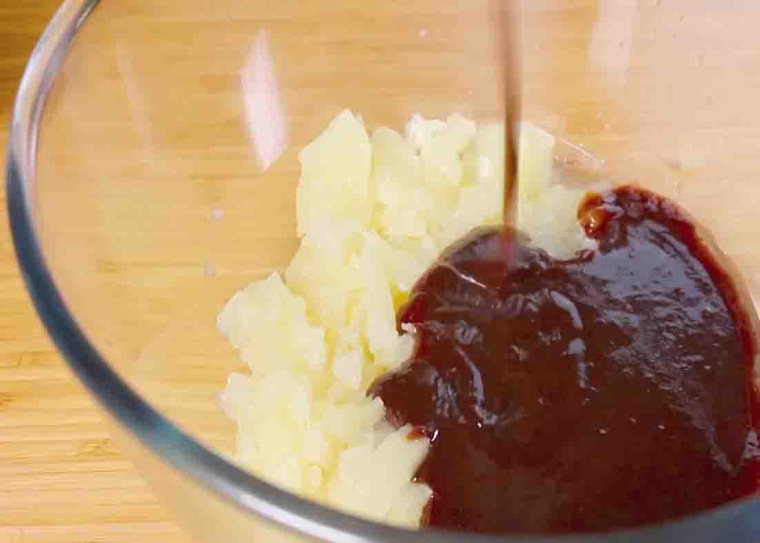 Mixing the diced pineapple and barbeque sauce for the Hawaiian chicken recipe