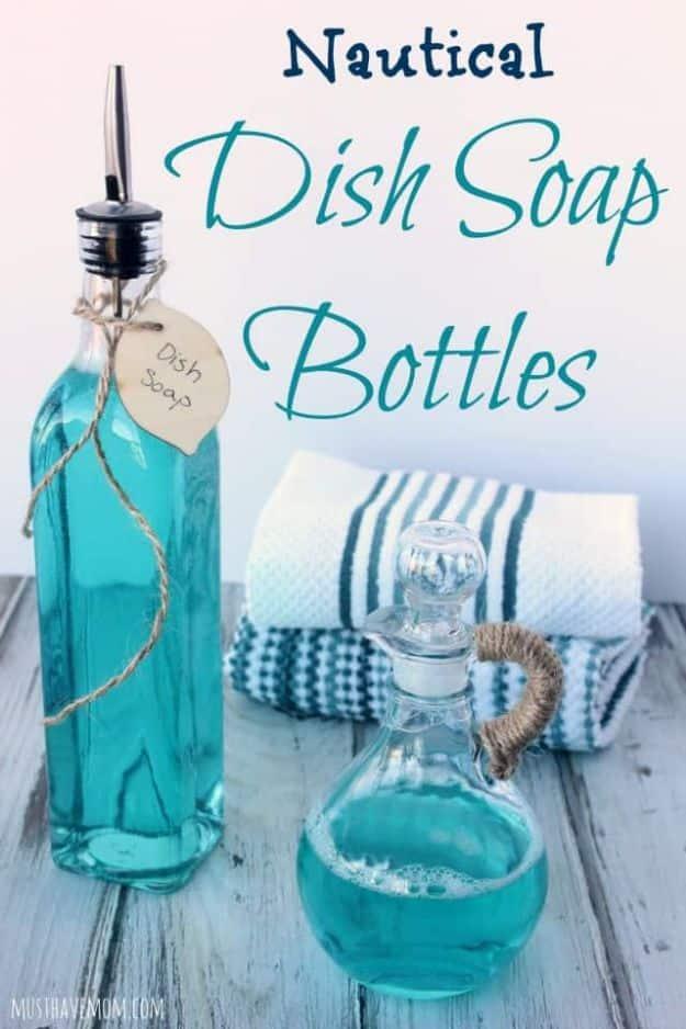 Two nautical dish soap bottles filled with blue soap, one with a pour spout and a wood tag, one a twine wrapped cruet