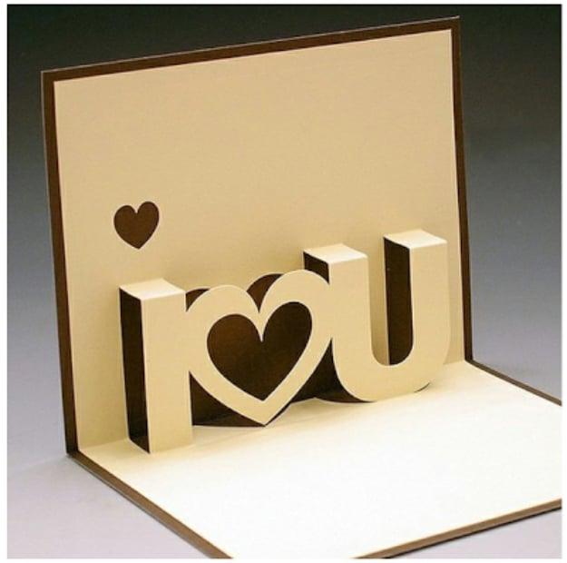 I Love You pop up card with the words cut from white paper standing up against a red layered backing