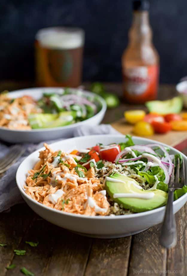 Buffalo chicken quinoa bowl with shredded chicken, avocado, cherry tomatoes, lettuce and ranch for an easy weeknight dinner