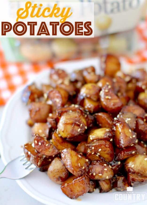Sticky potatoes recipe graphic with glossy browned potato chunks and sesame seeds on a white dinner plate