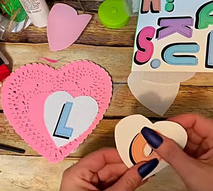 Learn to make a DIY Paper Doily Heart Banner with materials from Dollar Tree