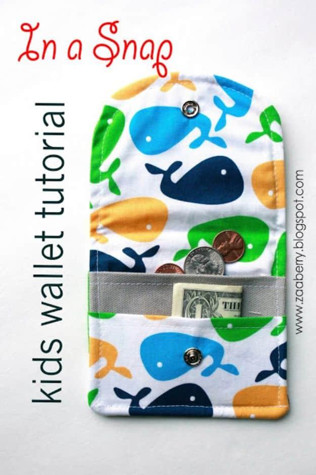 Kids wallet tutorial, an open whale print fabric wallet with a gray pocket holding a dollar bill and coins