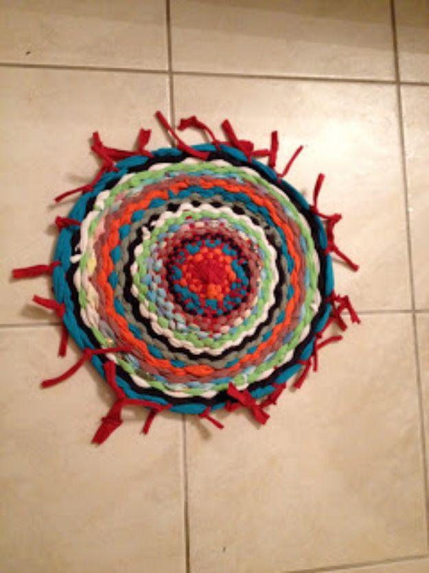 Small round woven DIY t-shirt rug in red teal green and black on tile with knotted fringe around the edge