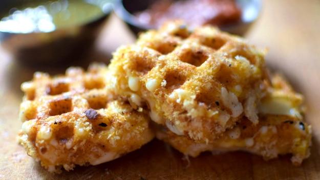 Breaded mozzarella cooked in a waffle iron into crisp ridged cheese squares with marinara in the divots