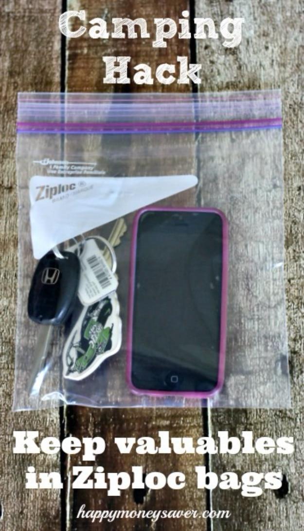 Camping hack graphic, a car key, keyring and phone sealed in a clear ziploc bag on weathered grey boards