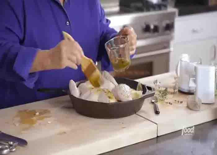 Brushing the herb oil on the chicken