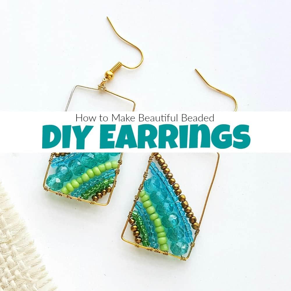 A pair of geometric gold wire earrings woven with diagonal rows of teal crystal, lime green and bronze beads on white
