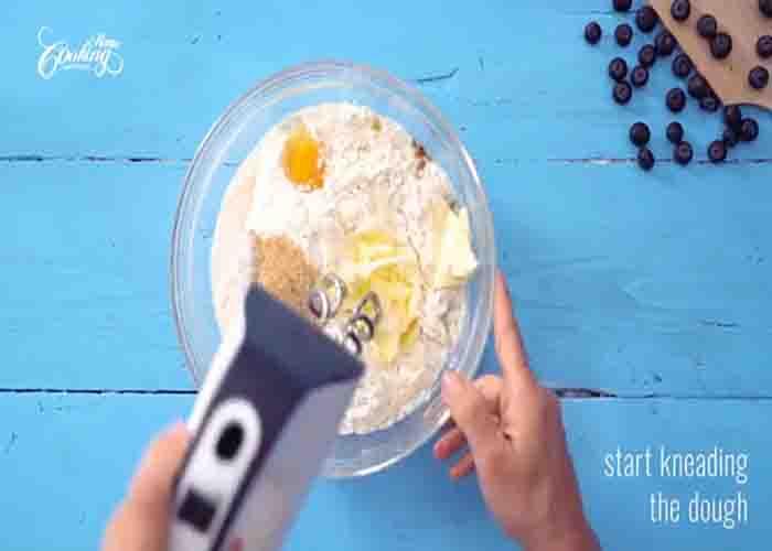 Mixing the mixture to make the blueberry bun dough