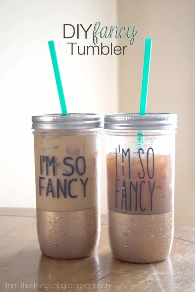 DIY fancy tumbler, two gold dipped mason jar tumblers lettered I'm So Fancy with teal straws and iced coffee