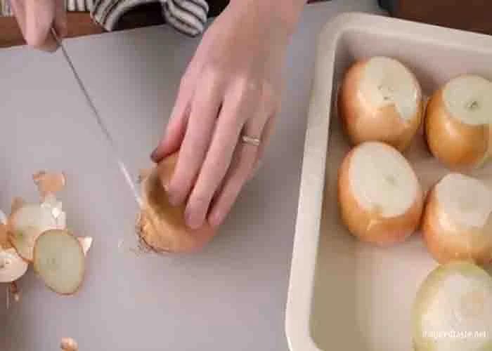 Trimming off the top and bottom of the onions before roasting them