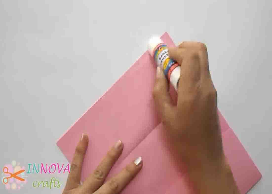 Gluing the DIY paper gift bag