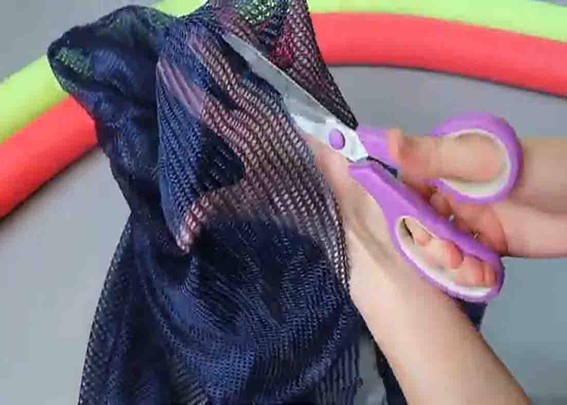 Cutting the mesh laundry bag open for the DIY seat float