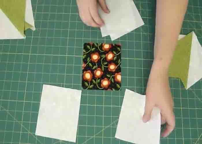 Laying the charm pack and the 5" squares to make the friendship star quilt block
