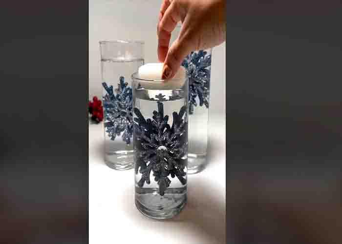 Adding the tea candle to the Christmas floating candle decoration