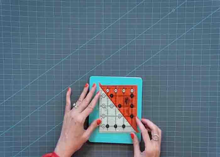 Trimming the half-square triangles for the gretchen quilt