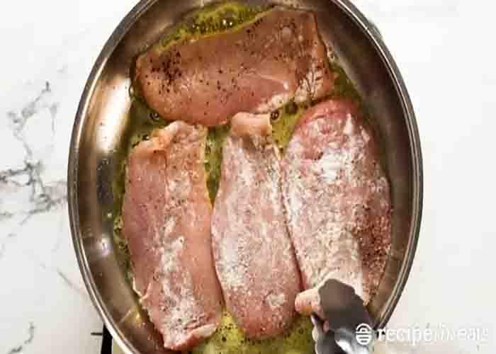 Frying the chicken breasts for the chicken with creamy mushroom sauce recipe