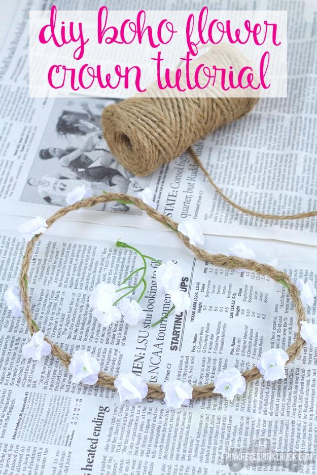 DIY boho flower crown, a braided jute crown set with small white flowers on newspaper beside a spool of twine