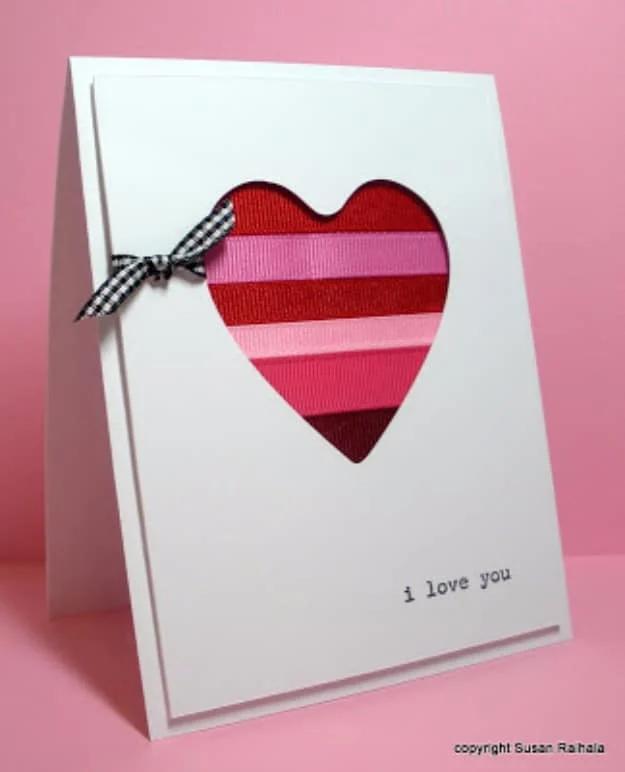 Ribbon scrap Valentine card with a heart shaped window in the mat showing striped ribbon offcuts behind it