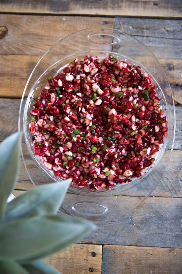 Cranberry jalapeno dip with chopped red cranberries and green jalapeno over a layer of whipped cream cheese