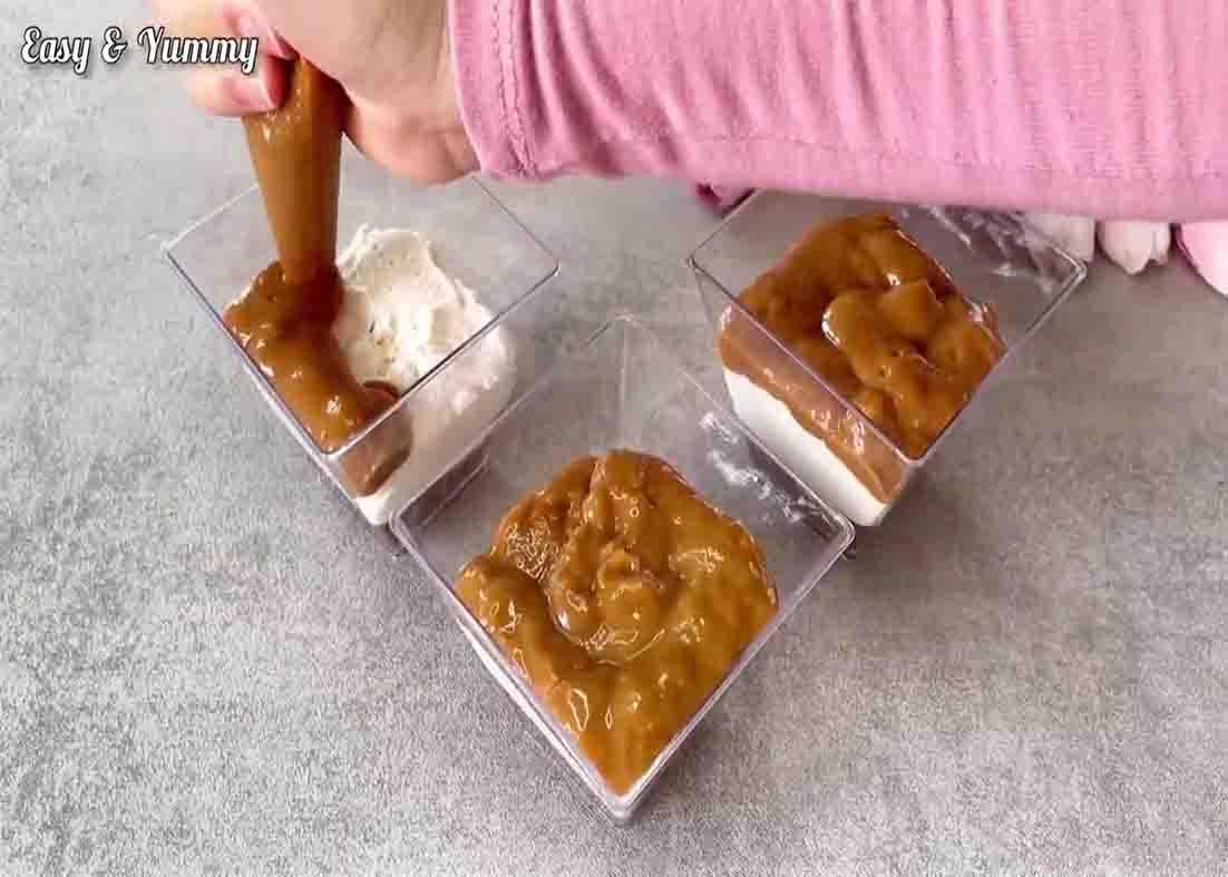 Layering the Twix dessert on the cups