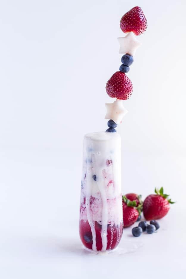 A firecracker berry margarita float mixed with fizz for a fun festive Fourth of July drink for the whole family