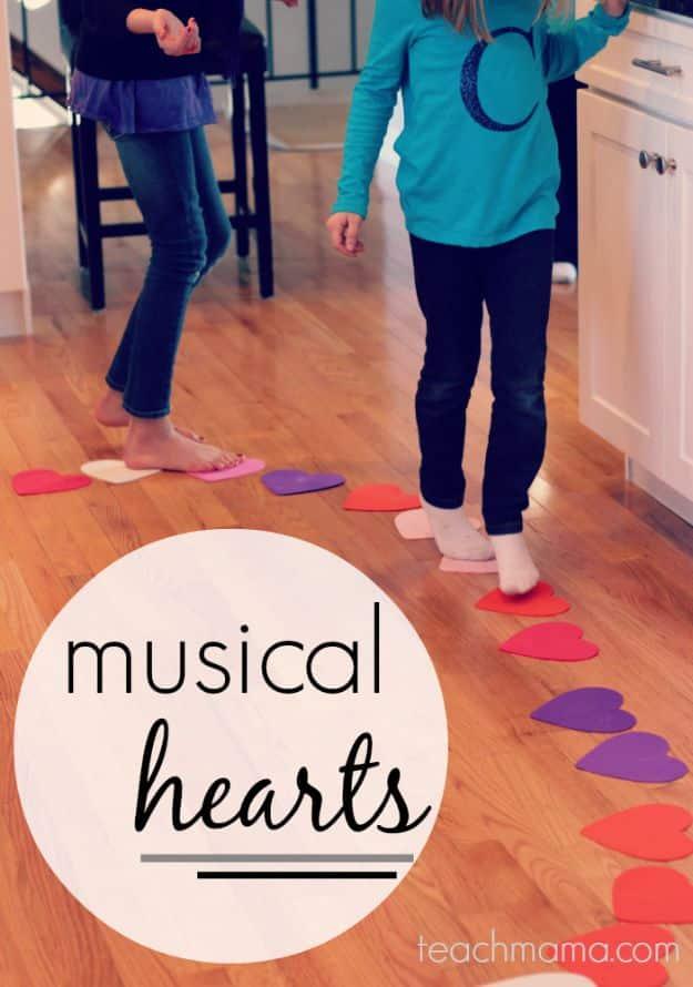 Musical hearts game with paper hearts taped across the floor and children moving between them to music