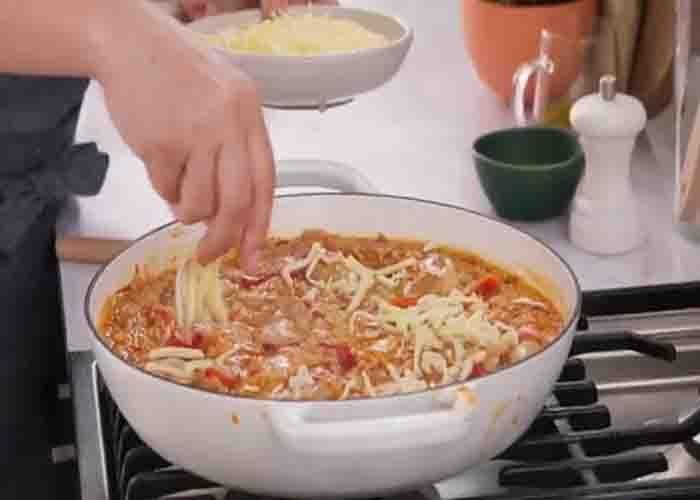 Topping the Mexican chicken and Rice Bake with grated cheese
