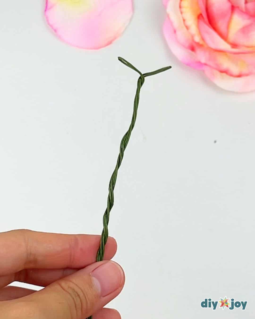 Toilet paper flower craft ideas, homemade paper roses in pastel shades displayed together on a table