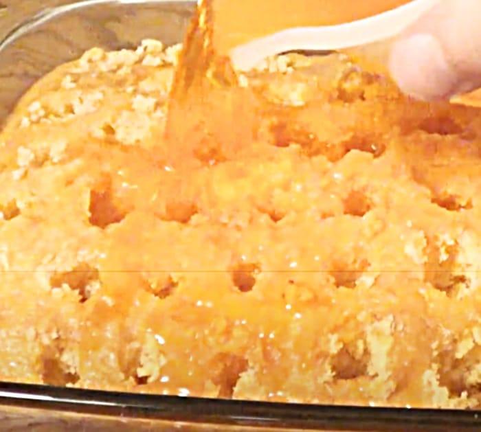 Poke Holes In A Cake To Pour Orange Jello To Make an Orange Creamsicle Poke Cake