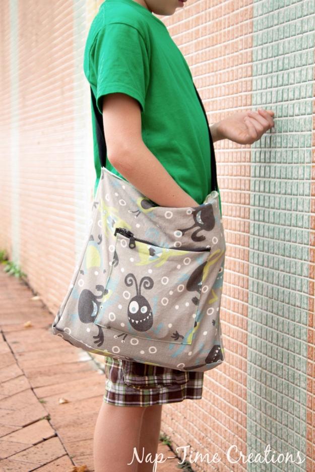 Sewing projects for boys messenger bag in gray monster print with a zip pocket, worn across the body by a child
