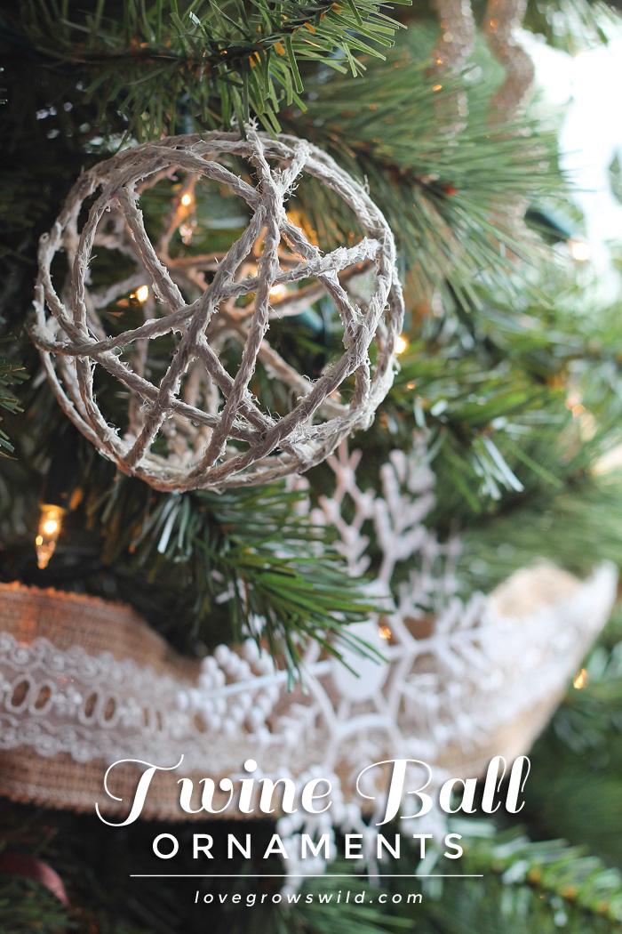 A rustic twine ball ornament in a lit Christmas tree above burlap and lace ribbon, with the words Twine Ball Ornaments below