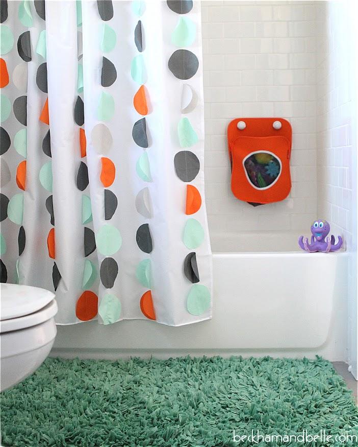 DIY shower curtain sewing project for the home, a white curtain with orange gray and teal dots in a kid's bathroom