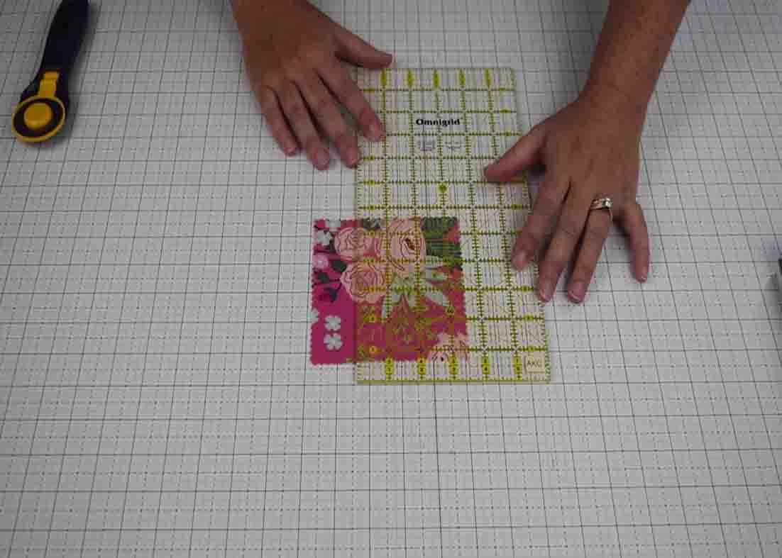 Lining up the ruler to the fabric to make the interweave quilt