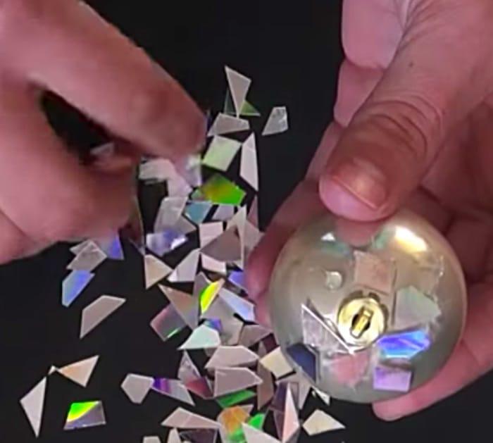 Learn to make this quick easy DIY Disco Ball Christmas Ornament using old CDs
