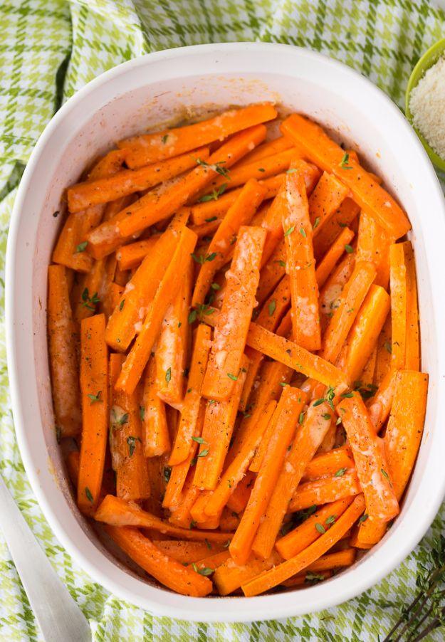 Parmesan roasted carrot sticks browned at the edges and scattered with grated cheese and fresh thyme