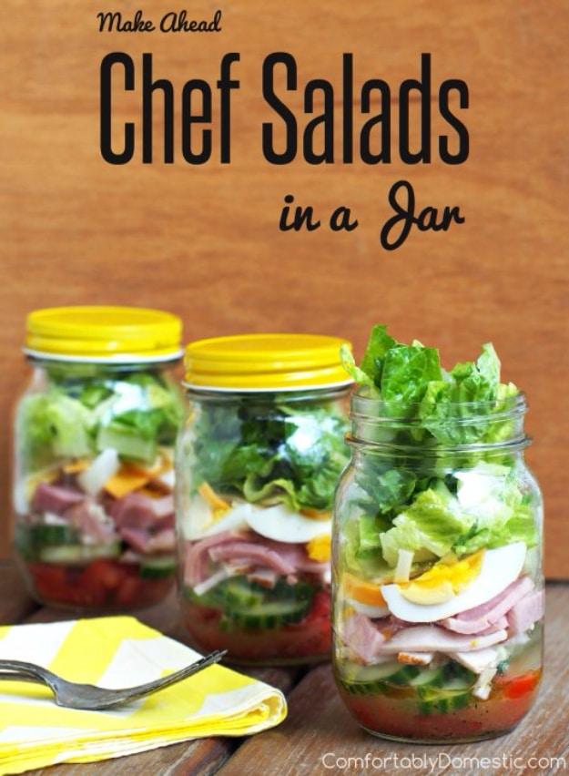 Chef salad in a jar with ham, turkey, hard boiled egg, cheese and romaine stacked over Parmesan vinaigrette