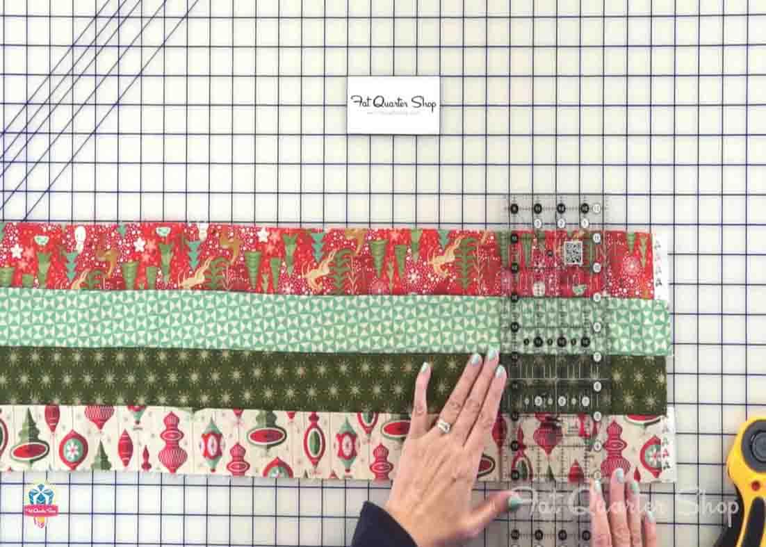 Cutting the jelly roll strips for the railway quilt