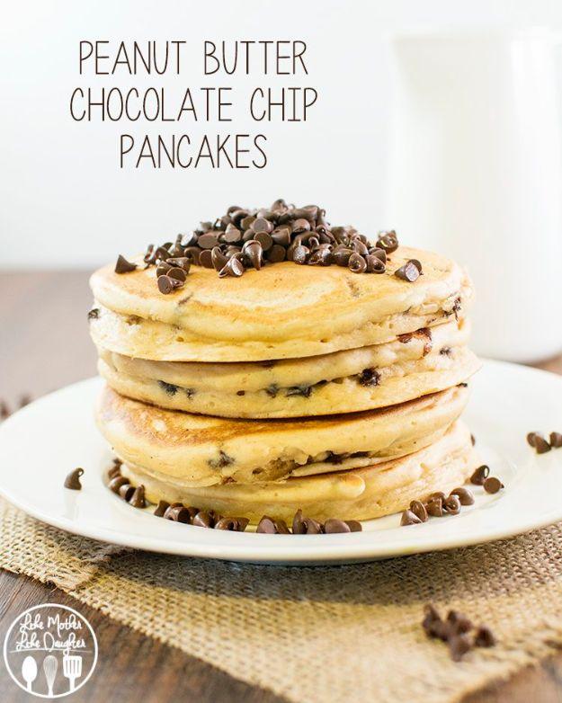 Peanut butter chocolate chip pancakes stacked on a plate with mini chocolate chips scattered all around