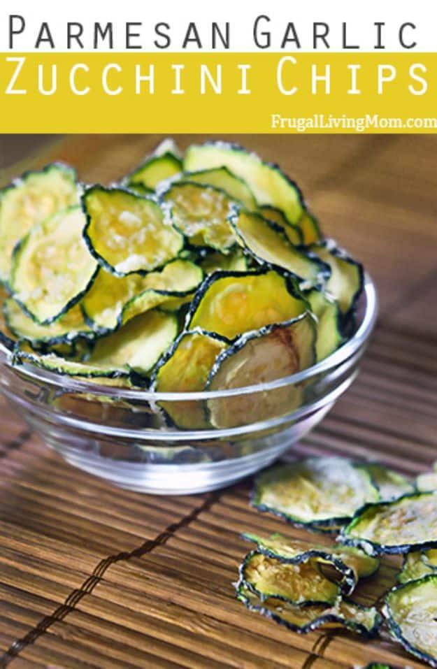 Parmesan garlic zucchini chips pin graphic, a glass bowl of crisp browned zucchini slices with a title