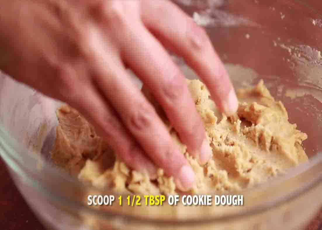 Scooping the dough to form the pumpkin snickerdoodle cookies