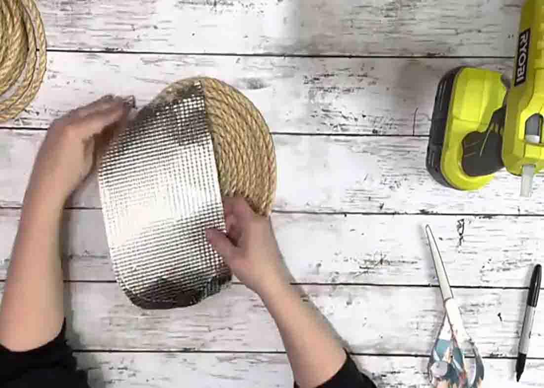 Attaching the cookie sheet to the burner cover to make a pocket for the faux flowers