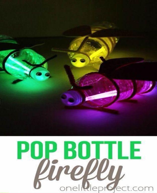 Three bottle fireflies in green, yellow and purple glowing in the dark with pipe cleaner legs and foam wings