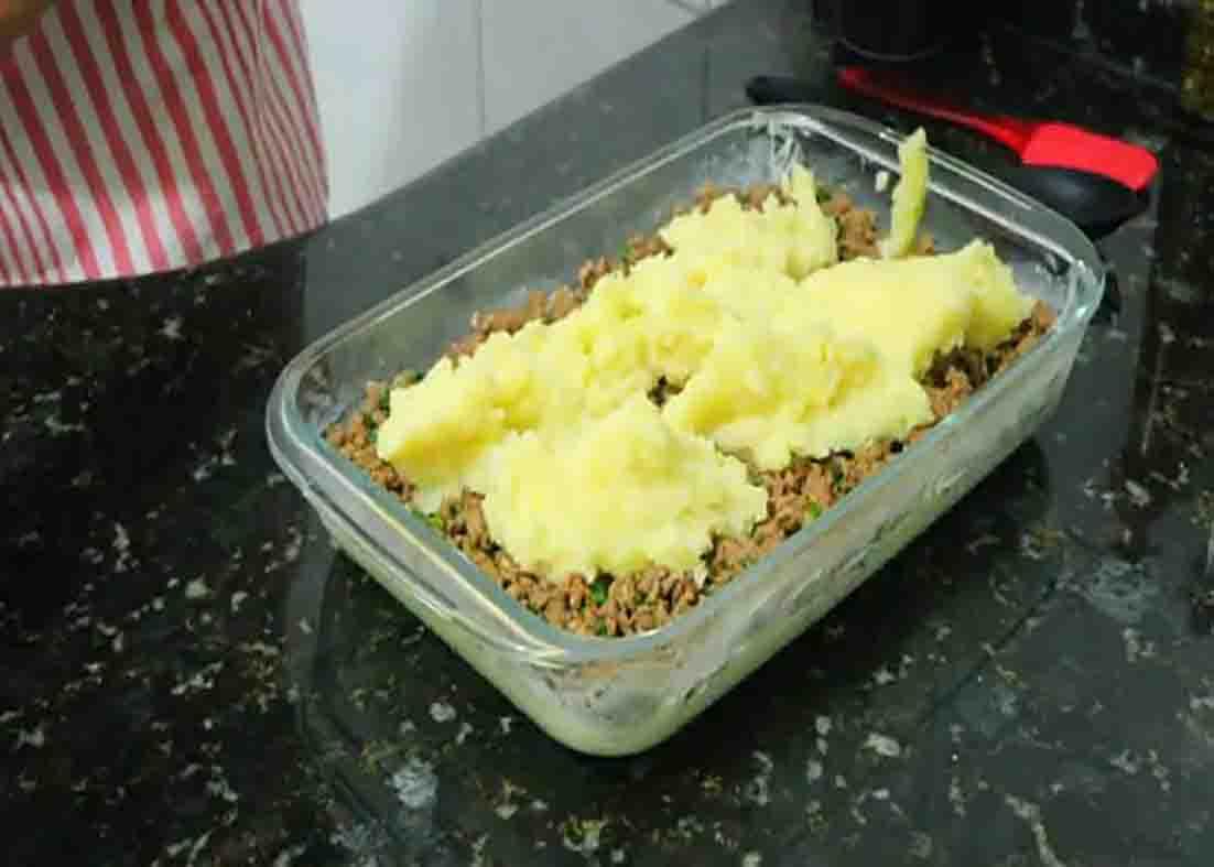 Assembling the gratin potato with ground beef casserole