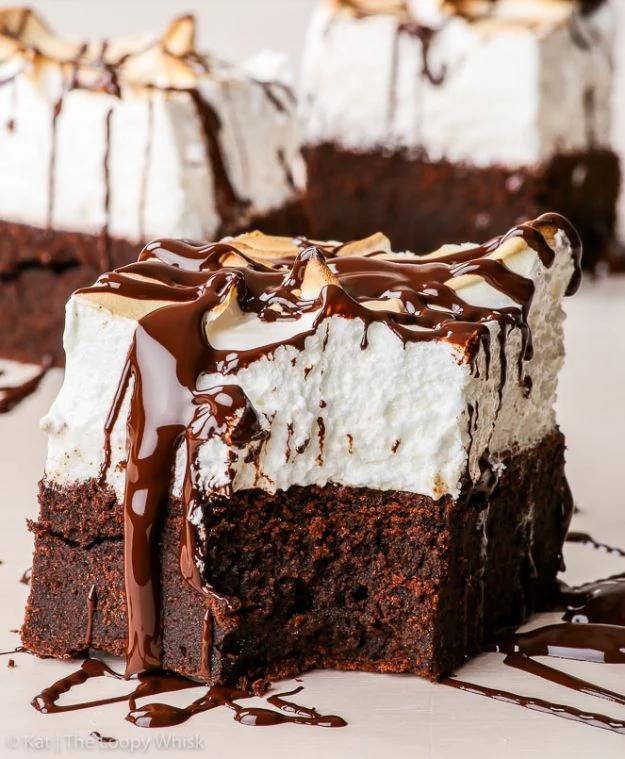 Sky high gluten free marshmallow brownies with a thick white marshmallow layer and chocolate drizzle