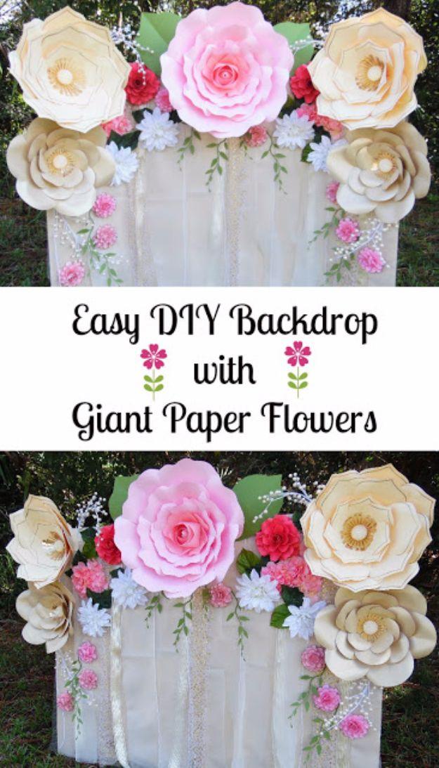 Paper flower backdrop, giant cream and pink paper flowers glued across a fabric draped tabletop backdrop