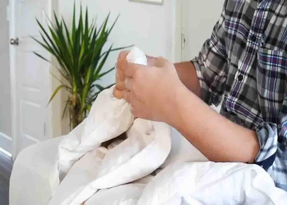 Breaking apart the fibers of your comforter to fluff it again