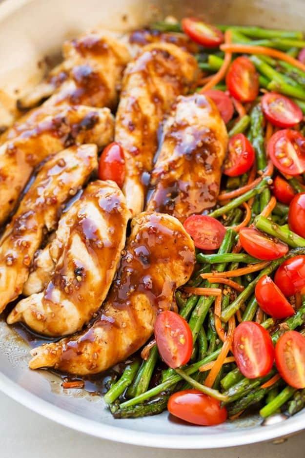 One pan balsamic chicken and veggies in a steel pan, glazed tenderloins with asparagus, carrot and tomatoes