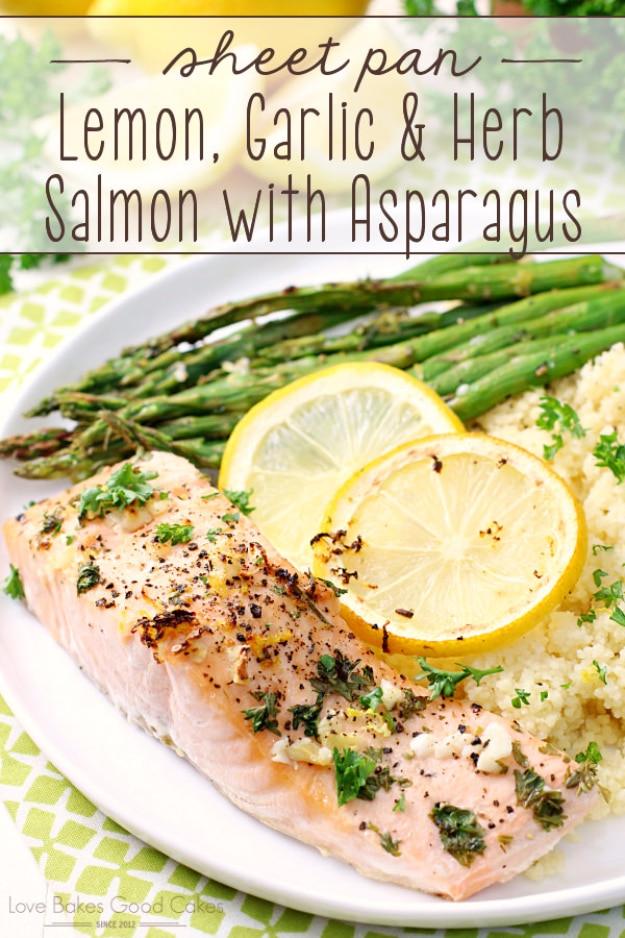 Sheet pan lemon garlic herb salmon fillets roasted alongside asparagus spears and thin lemon slices ready to serve at home