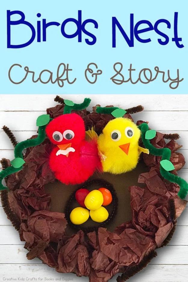 Tissue paper birds nest craft holding two pom pom chicks and small candy eggs, set out on white boards